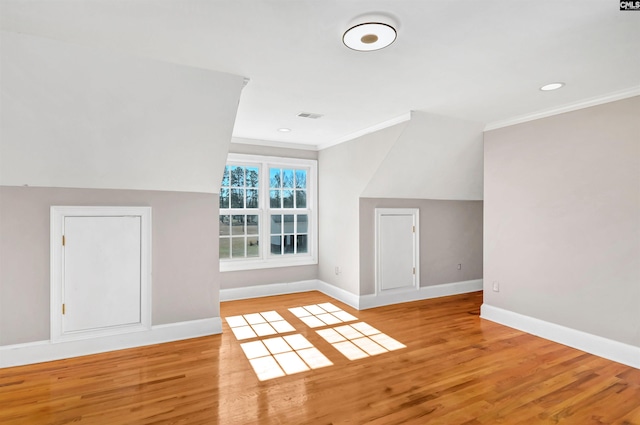 additional living space with recessed lighting, visible vents, baseboards, and wood finished floors