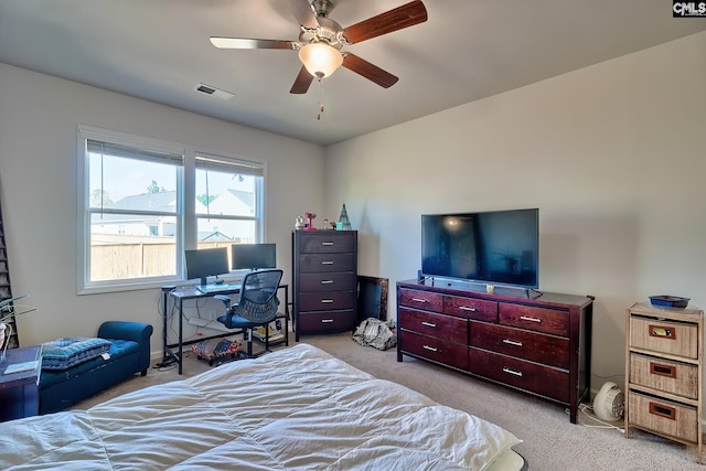 bedroom featuring visible vents, ceiling fan, and light carpet