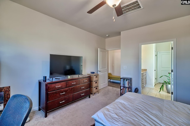 bedroom featuring baseboards, visible vents, connected bathroom, light colored carpet, and ceiling fan