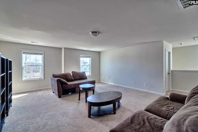 living area featuring light carpet, visible vents, and baseboards