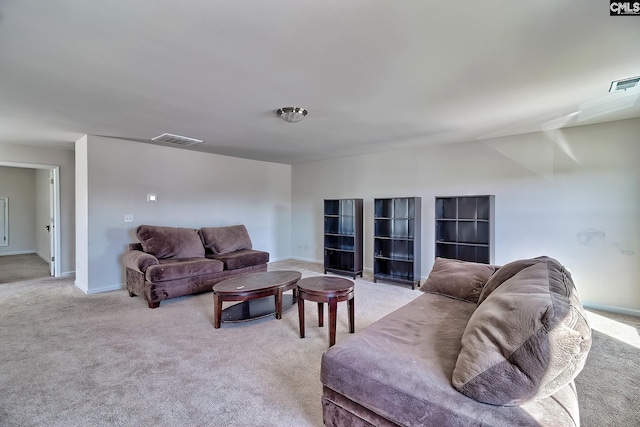 living area featuring light carpet, visible vents, and baseboards