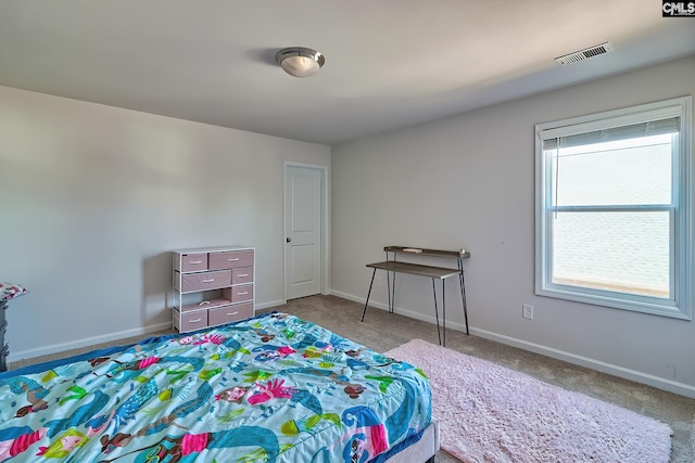 bedroom with carpet floors, visible vents, and baseboards