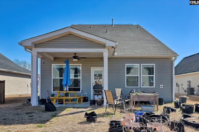 back of house featuring a ceiling fan, roof with shingles, a patio, and central AC