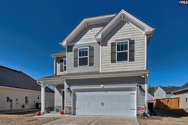 craftsman inspired home featuring driveway, an attached garage, and fence