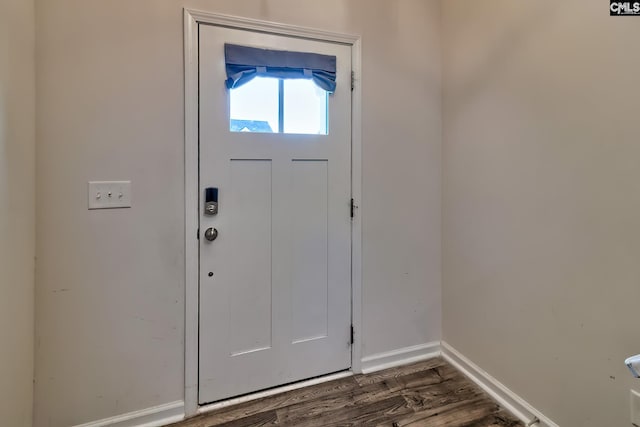 entryway featuring dark wood-style flooring and baseboards