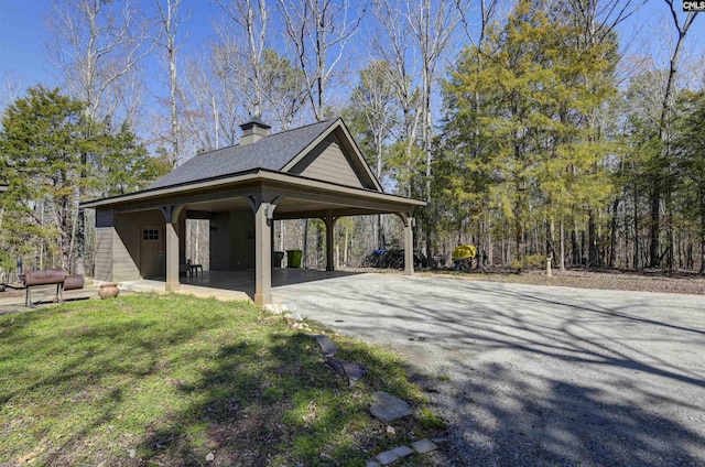 surrounding community with a yard, driveway, and a carport