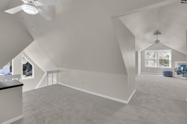 bonus room with lofted ceiling, carpet, baseboards, and a ceiling fan