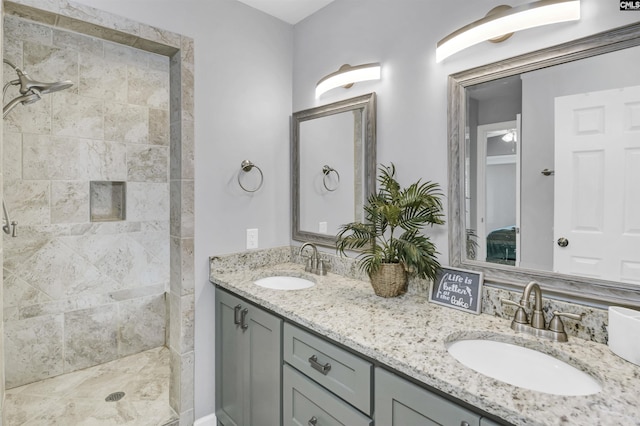 full bath with double vanity, a sink, and a shower stall