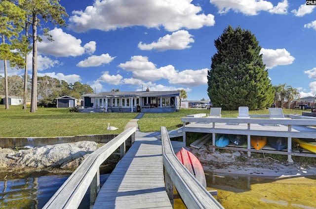 view of dock featuring a lawn