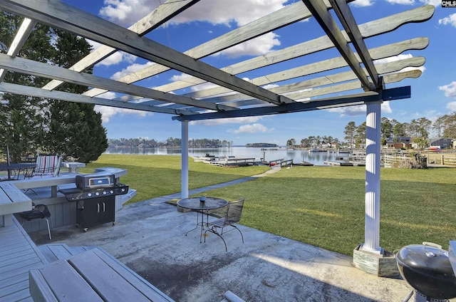 exterior space featuring a patio area, a lawn, a water view, and a pergola