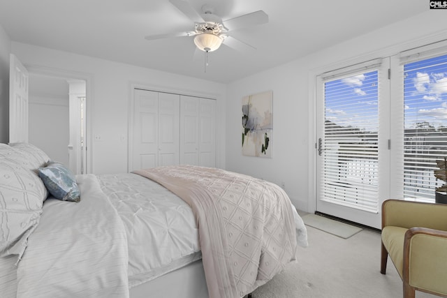 bedroom featuring access to outside, light colored carpet, a closet, and ceiling fan