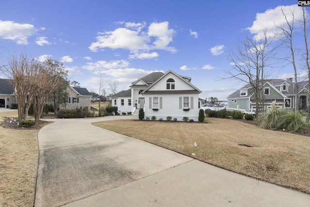 view of front of property with a residential view, driveway, and a front yard