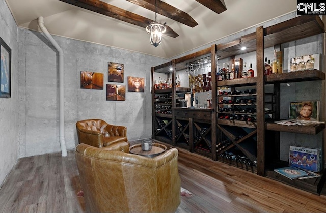 wine cellar featuring beamed ceiling and wood finished floors