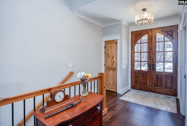 foyer with ornamental molding, wood-type flooring, baseboards, and french doors