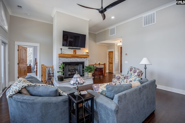 living room featuring a fireplace, dark wood finished floors, and visible vents