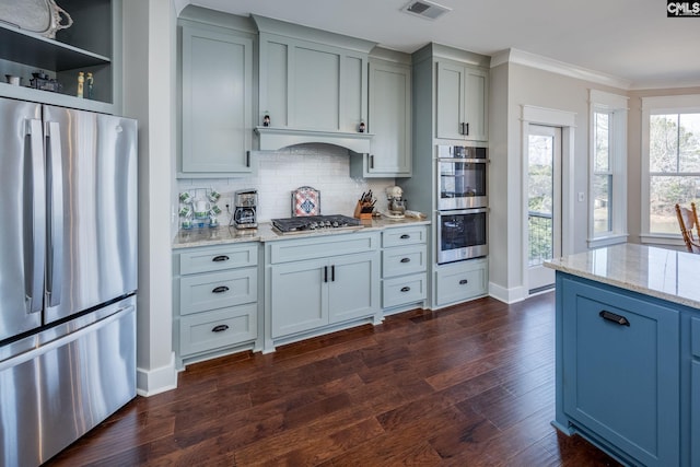 kitchen featuring visible vents, ornamental molding, dark wood-type flooring, light stone countertops, and stainless steel appliances