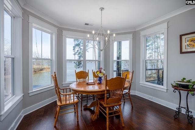 dining space with baseboards, dark wood-type flooring, visible vents, and crown molding