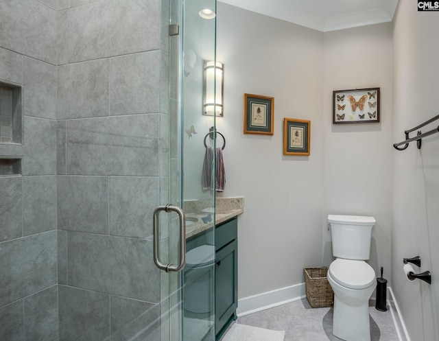 full bath with baseboards, toilet, crown molding, vanity, and a shower stall