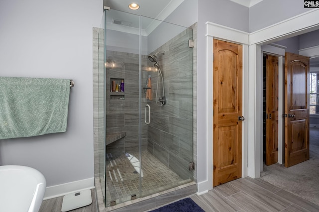 bathroom with a soaking tub, a shower stall, and visible vents