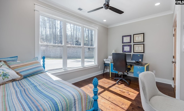 bedroom featuring baseboards, visible vents, crown molding, and wood finished floors