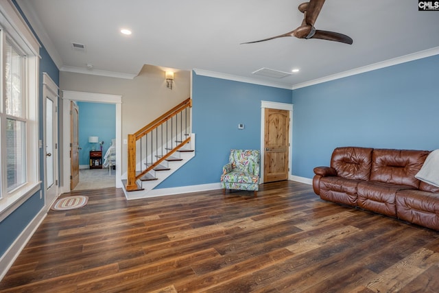 living room with stairs, crown molding, wood finished floors, and baseboards