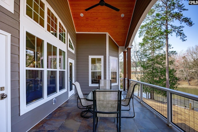 balcony with outdoor dining area and ceiling fan