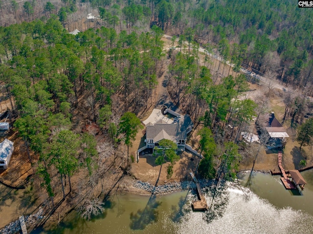 aerial view with a water view and a wooded view