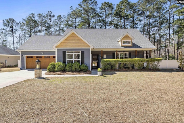 view of front facade with a garage, driveway, a front lawn, and roof with shingles