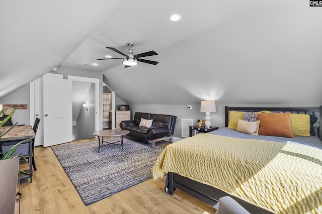 bedroom with a ceiling fan, vaulted ceiling, wood finished floors, and recessed lighting