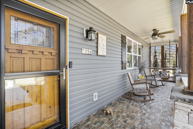 property entrance with covered porch and ceiling fan