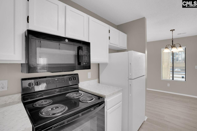 kitchen featuring white cabinets, light stone countertops, black appliances, an inviting chandelier, and pendant lighting