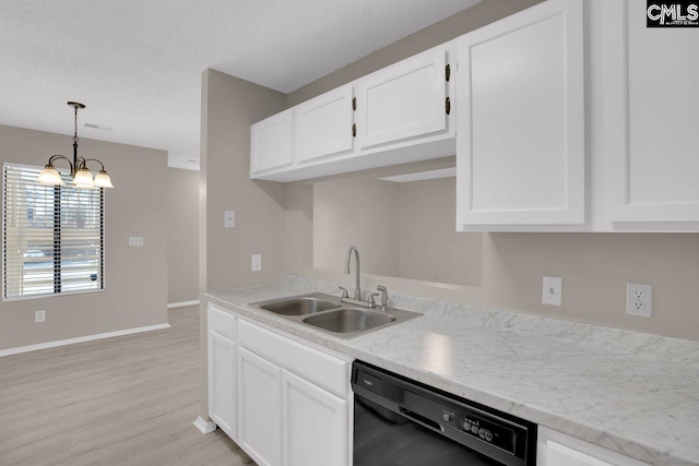 kitchen with black dishwasher, light countertops, a sink, and white cabinetry