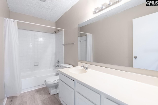 bathroom with toilet, wood finished floors, shower / bathtub combination with curtain, a textured ceiling, and vanity