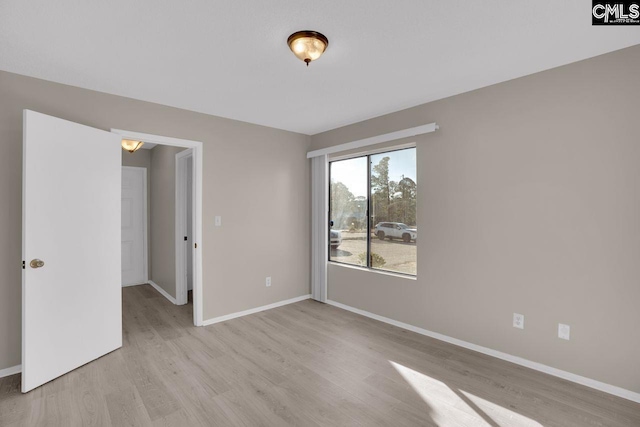 interior space featuring light wood-style flooring and baseboards