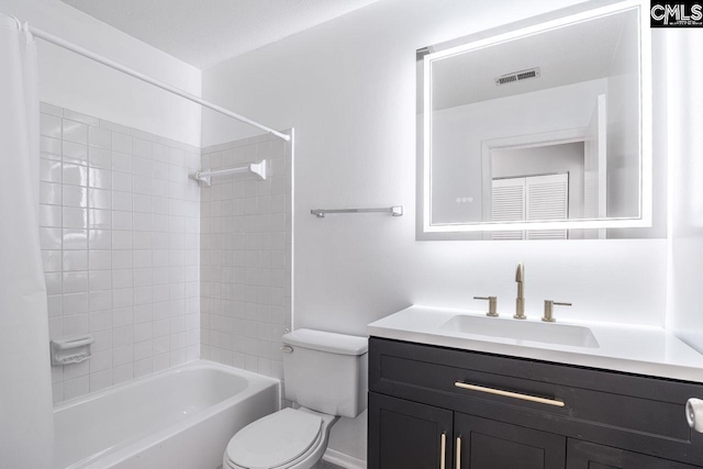 bathroom featuring visible vents, vanity, toilet, and bathing tub / shower combination