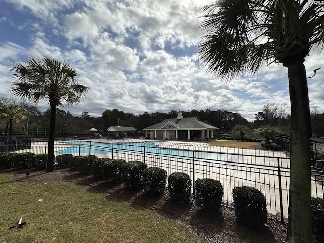 community pool with a patio and fence