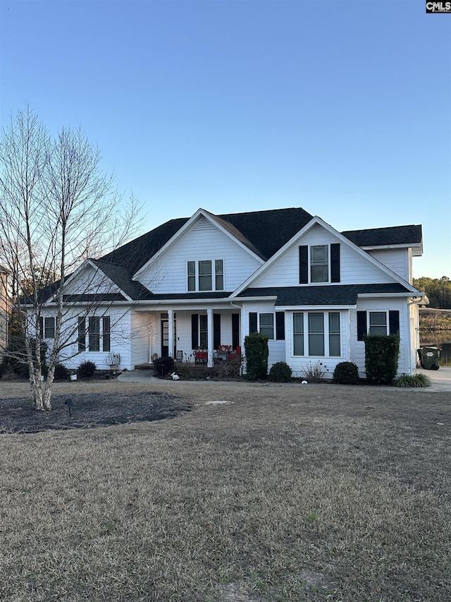 view of front of home featuring a porch and a front lawn