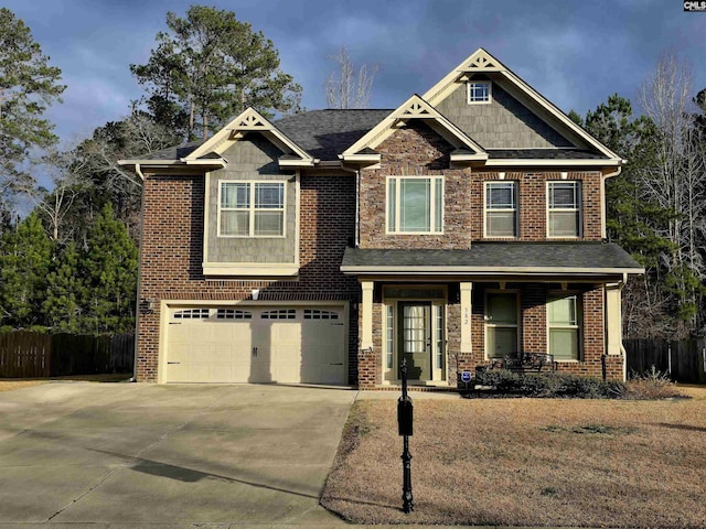 craftsman-style house featuring brick siding, a porch, concrete driveway, an attached garage, and fence