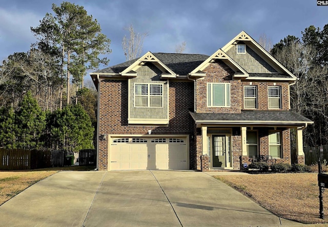 craftsman-style house with a porch, a garage, brick siding, fence, and concrete driveway