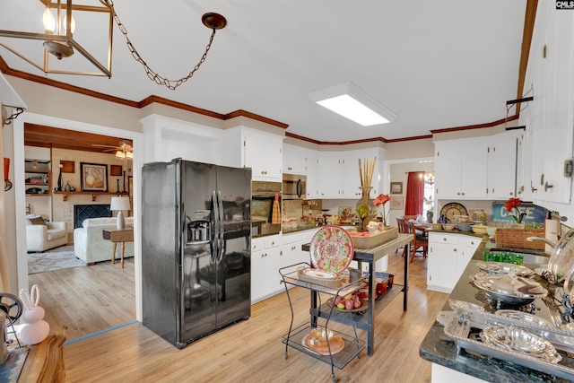 kitchen featuring dark countertops, light wood-style flooring, stainless steel microwave, and black fridge with ice dispenser