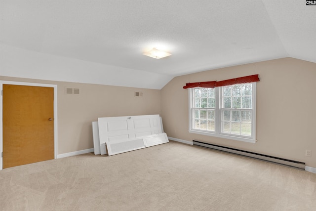 bonus room with visible vents, baseboards, vaulted ceiling, carpet floors, and a baseboard heating unit