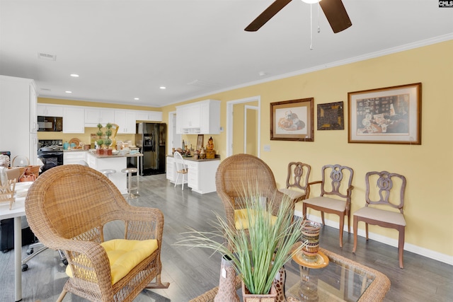 living area with light wood finished floors, baseboards, ornamental molding, and recessed lighting