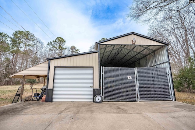 garage with concrete driveway and a detached garage