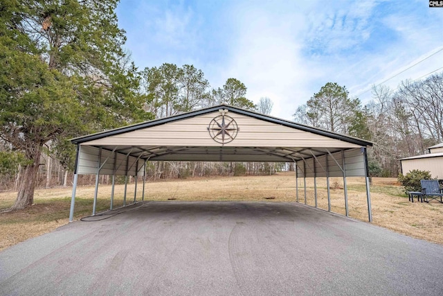 view of parking / parking lot featuring aphalt driveway and a carport