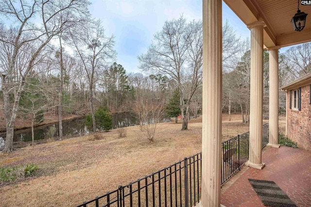 view of yard featuring fence and a porch