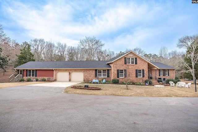 traditional-style home with concrete driveway, brick siding, and an attached garage