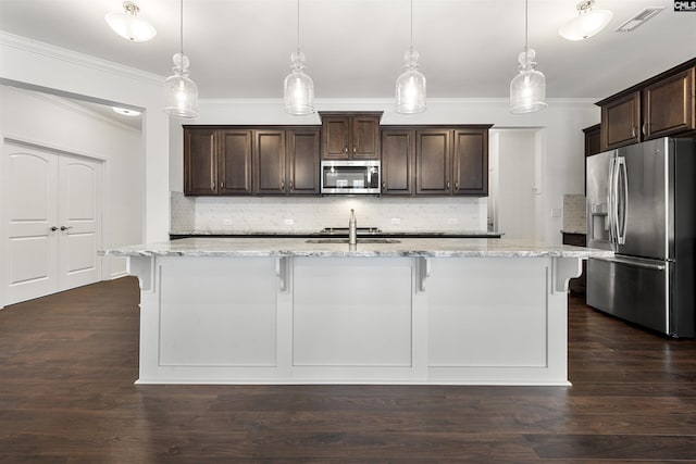 kitchen with stainless steel appliances, dark brown cabinetry, a breakfast bar area, and dark wood-style floors