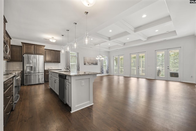 kitchen with appliances with stainless steel finishes, dark wood finished floors, beam ceiling, and open floor plan