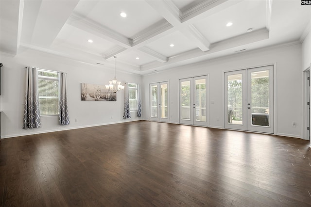 unfurnished living room with coffered ceiling, beamed ceiling, dark wood-type flooring, french doors, and a healthy amount of sunlight