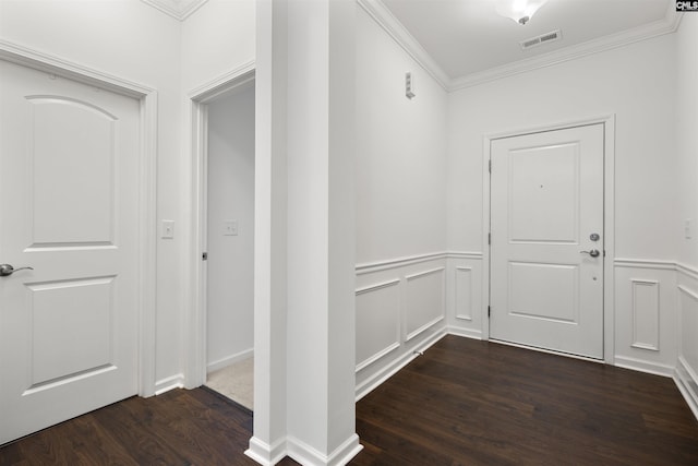 interior space featuring visible vents, dark wood finished floors, a wainscoted wall, crown molding, and a decorative wall